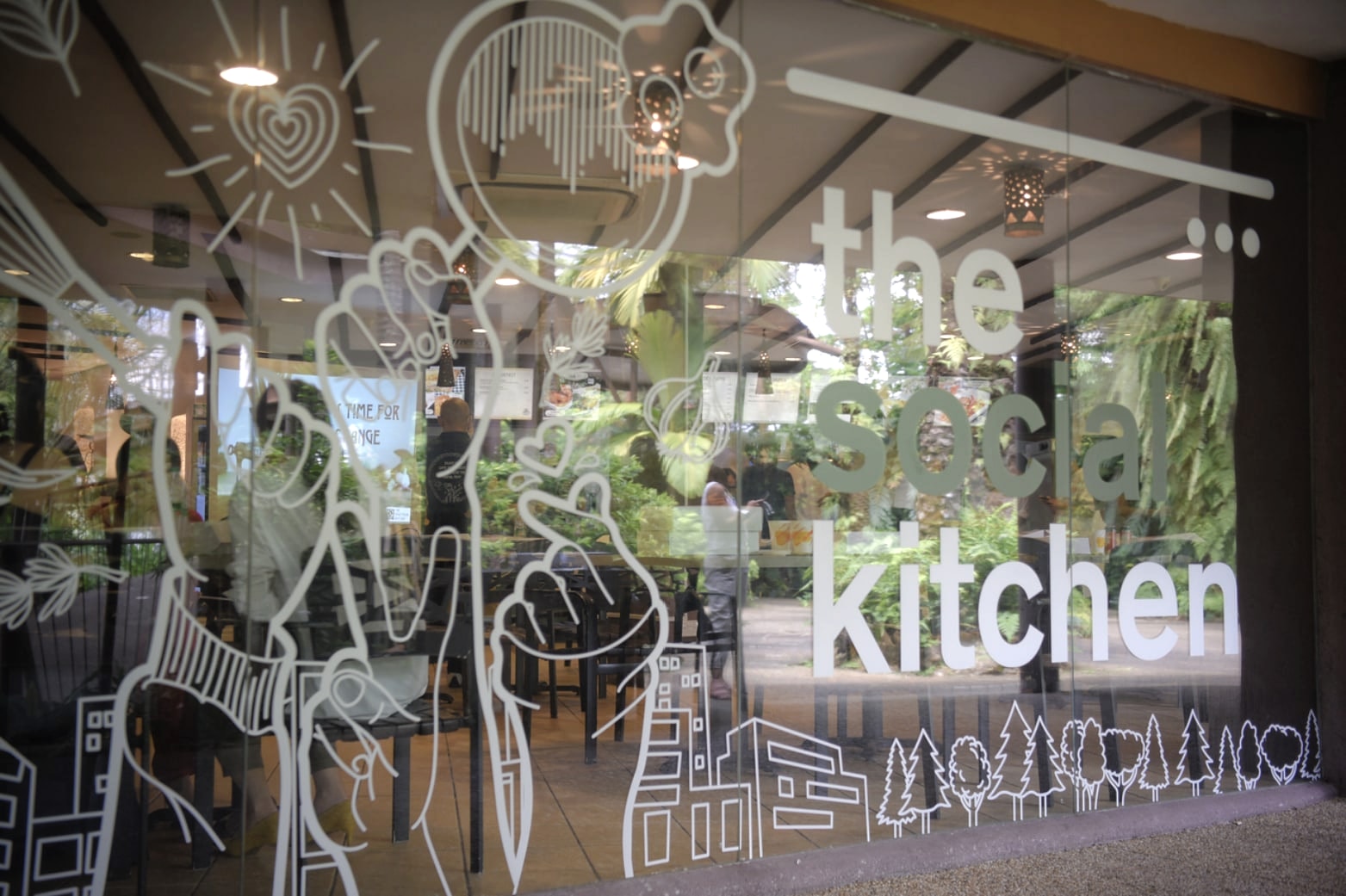 The Social Kitchen storefront with its name and illustrations across the window